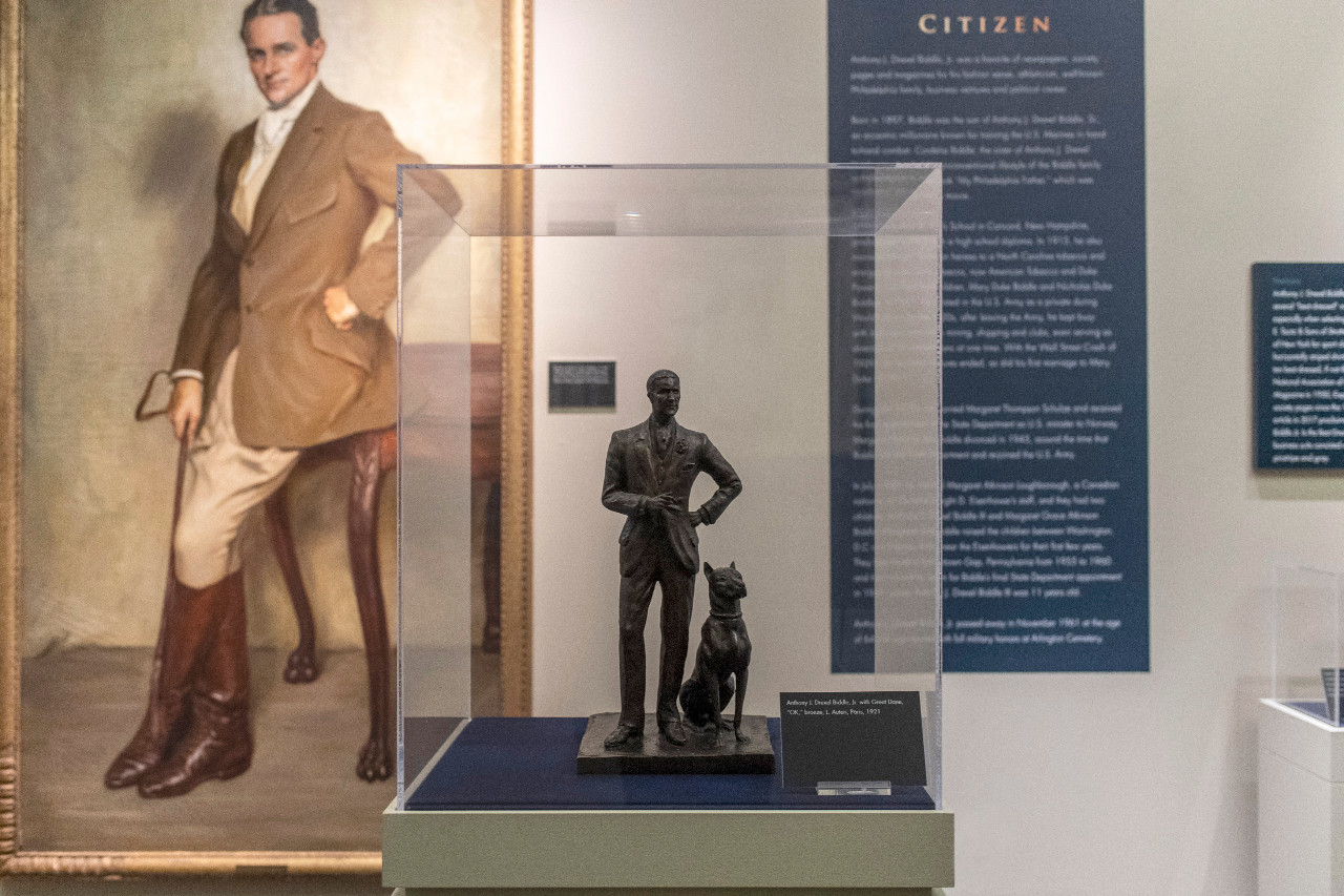 Display case with bronze sculpture of Anthony J. Drexel Biddle Jr.